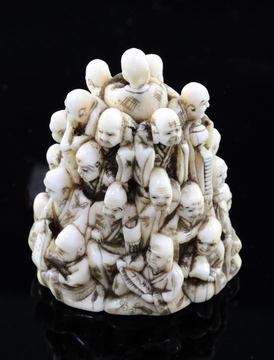 A Japanese ivory netsuke of multiple rakan, Meiji period, height 5.6cm